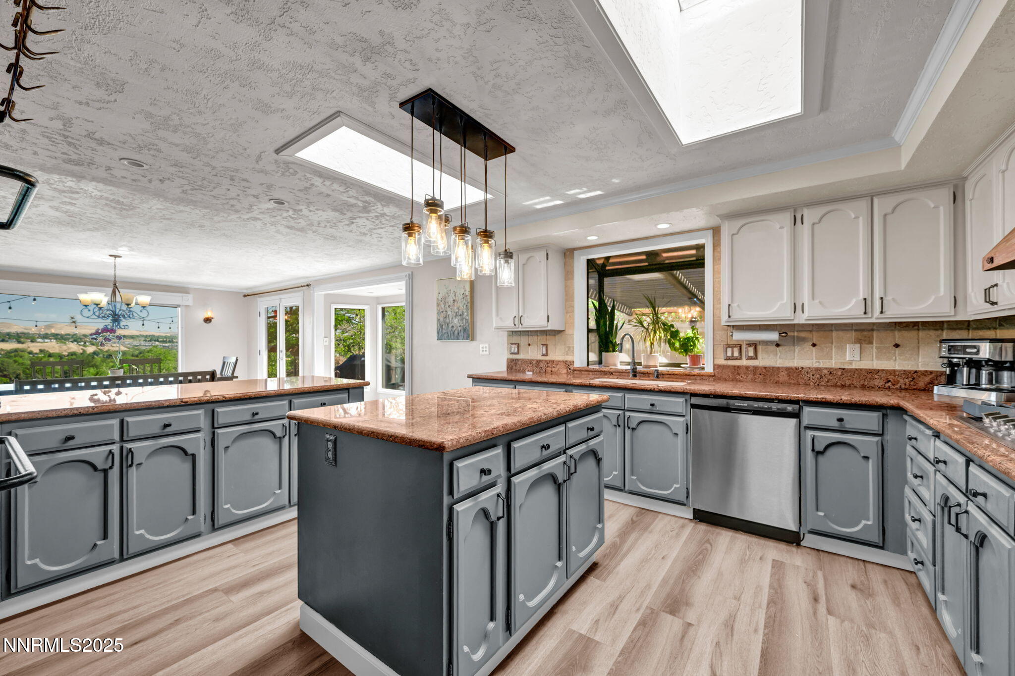 3495 West Plumb Lane Reno, NV 89509 - Photo 18 of 38 a kitchen with granite countertop cabinets stainless steel appliances a sink and a large window