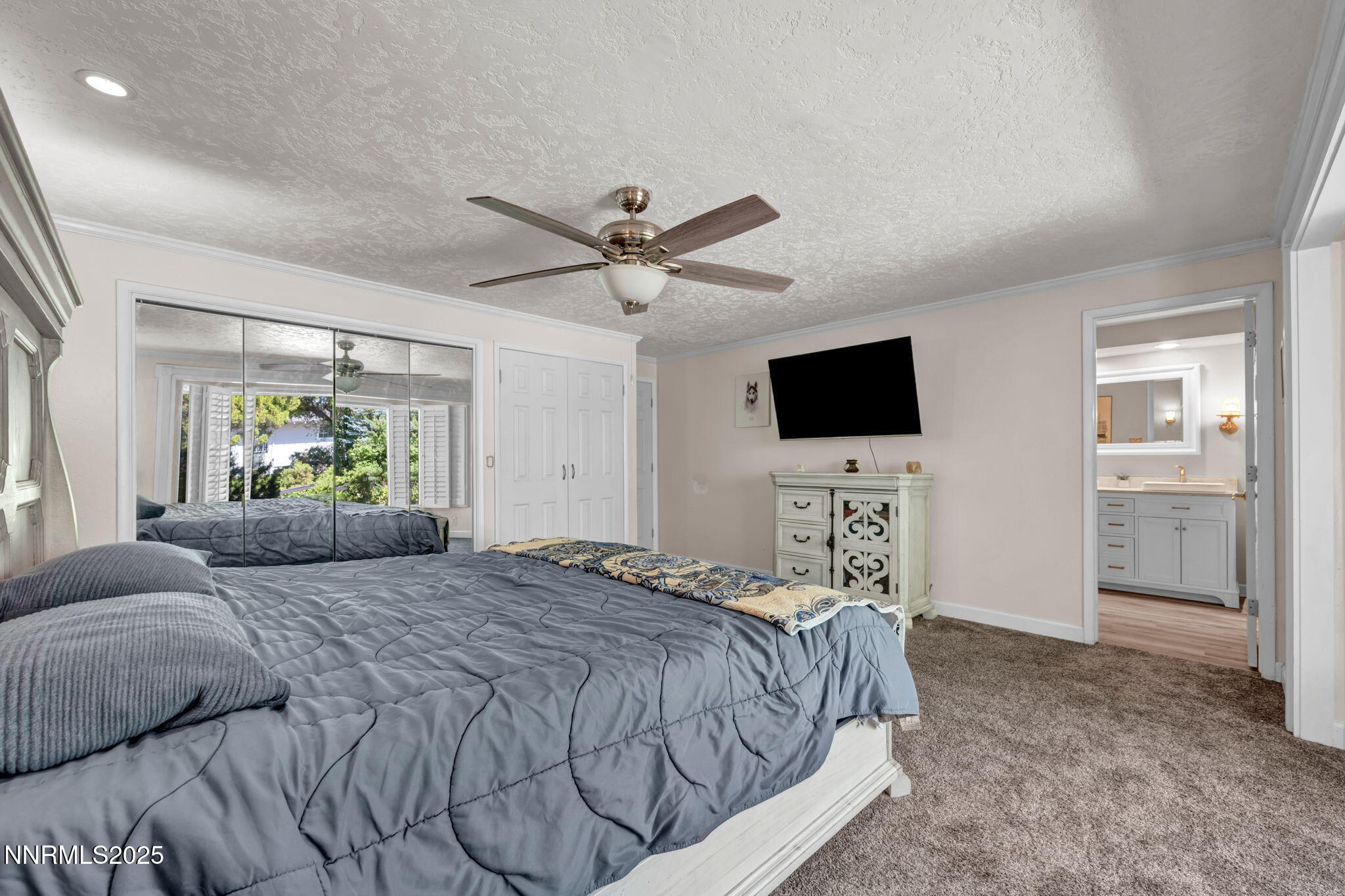 3495 West Plumb Lane Reno, NV 89509 - Photo 20 of 38 a bedroom with a bed and a flat screen tv