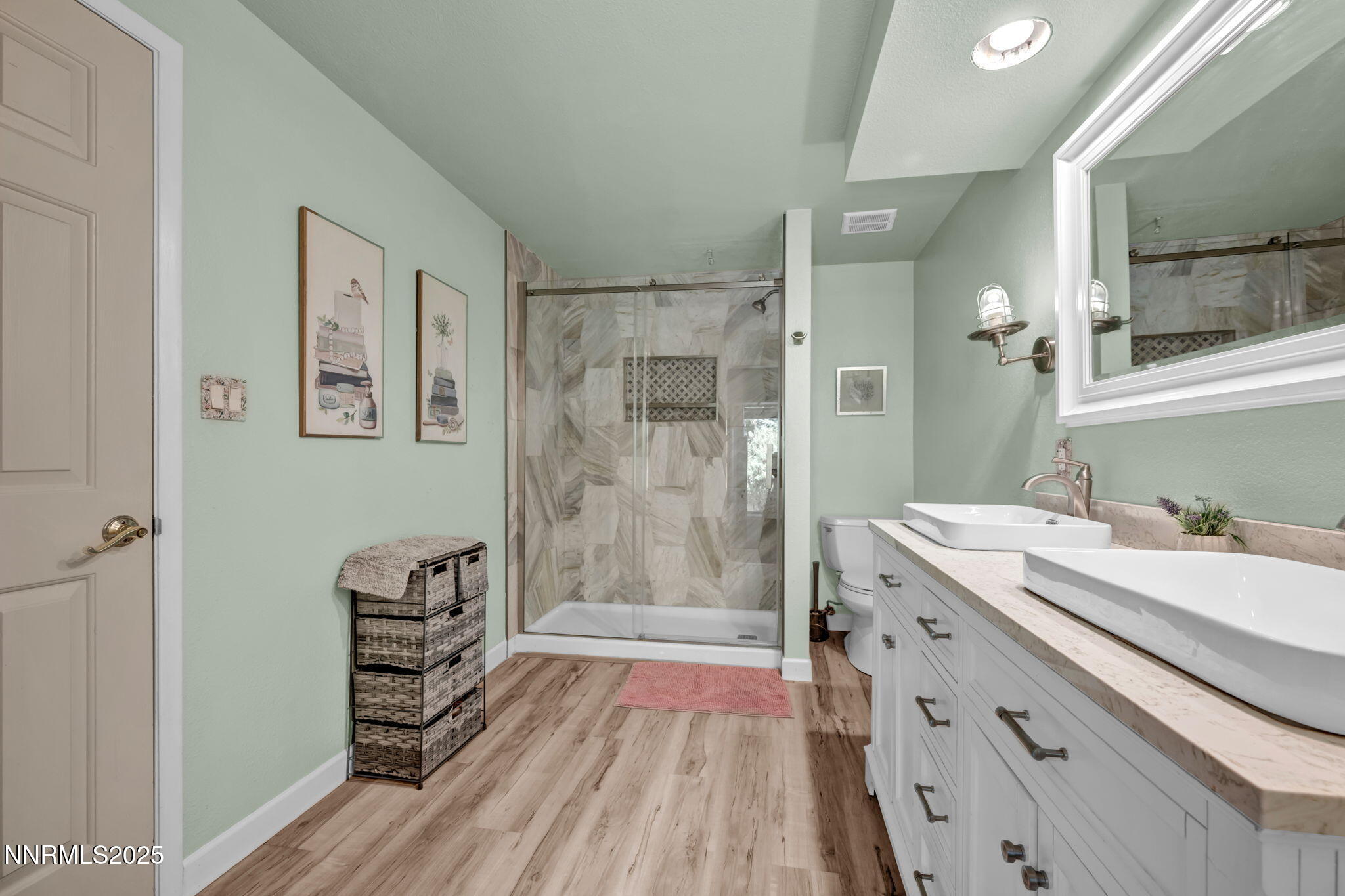 3495 West Plumb Lane Reno, NV 89509 - Photo 23 of 38 a bathroom with a sink a mirror a vanity and shower