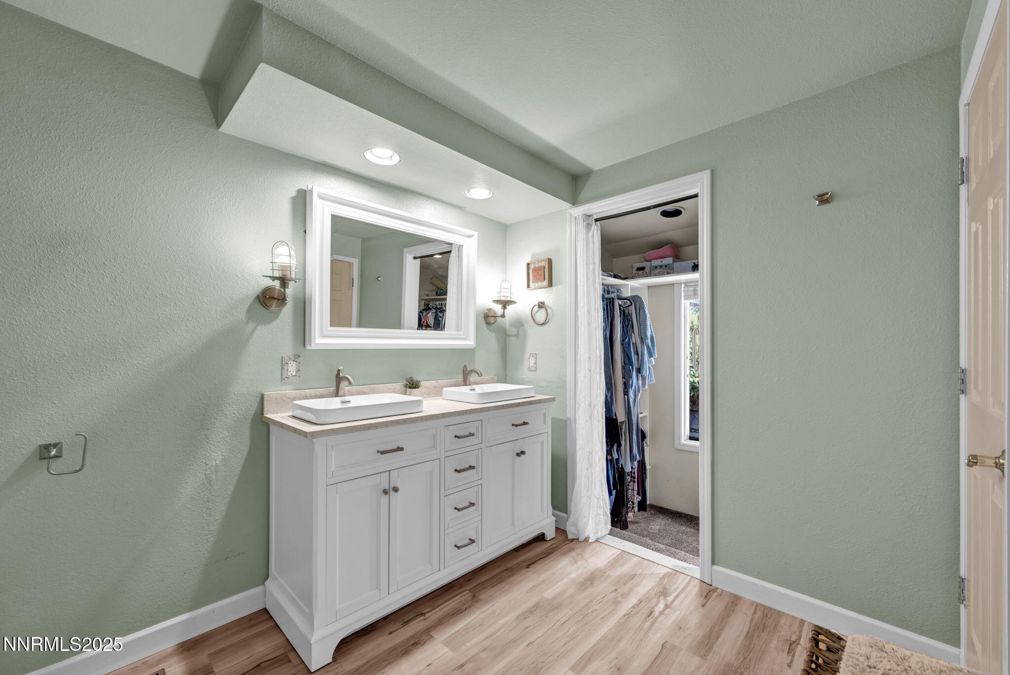 3495 West Plumb Lane Reno, NV 89509 - Photo 24 of 38 a spacious bathroom with a double vanity sink a large mirror and a shower