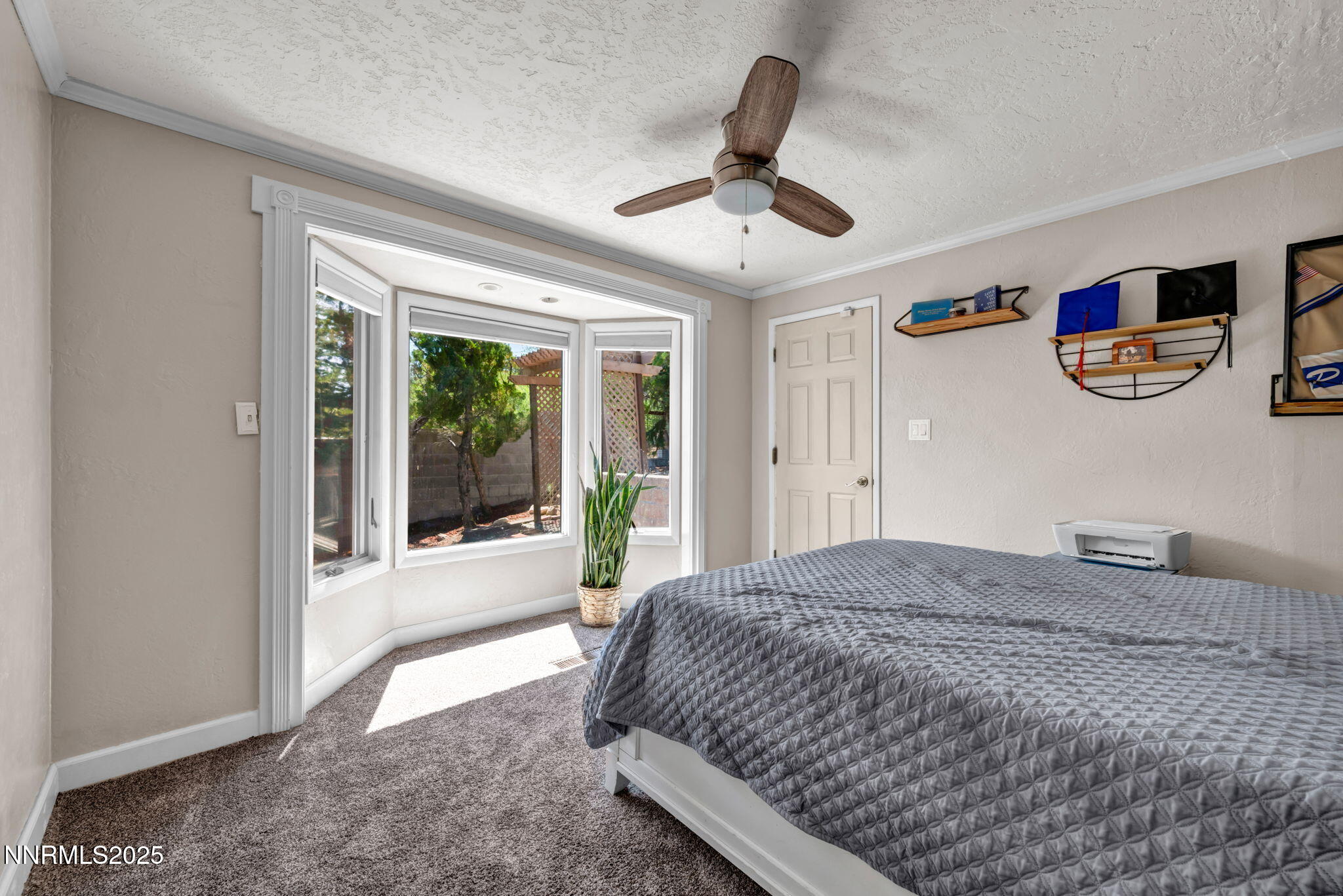 3495 West Plumb Lane Reno, NV 89509 - Photo 25 of 38 a spacious bedroom with a bed and a large window