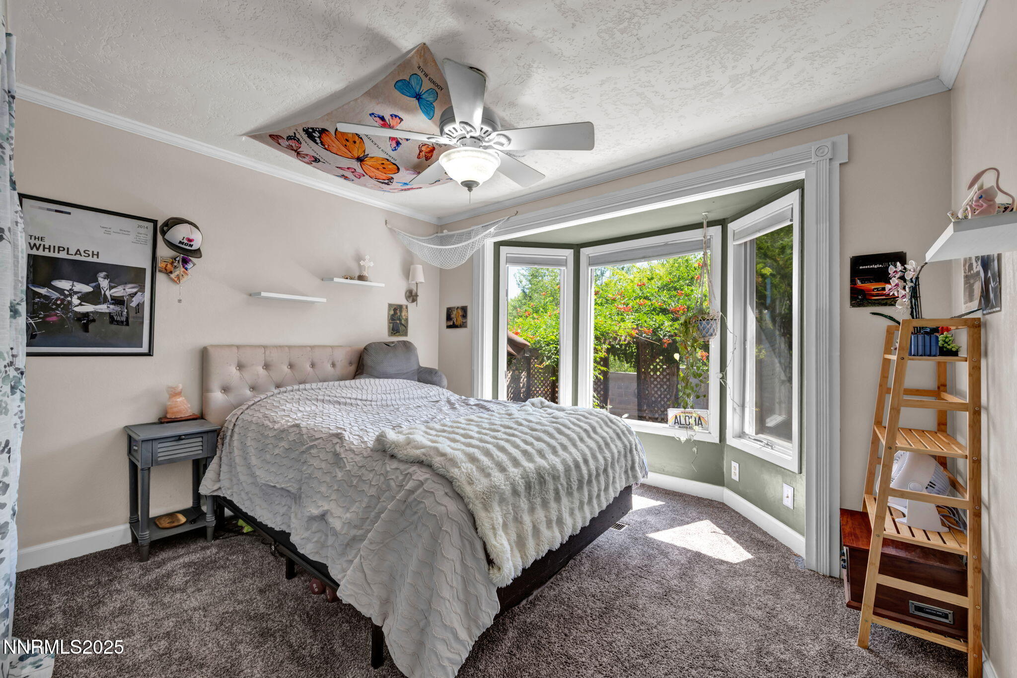 3495 West Plumb Lane Reno, NV 89509 - Photo 26 of 38 a bedroom with a bed a dresser and a large window