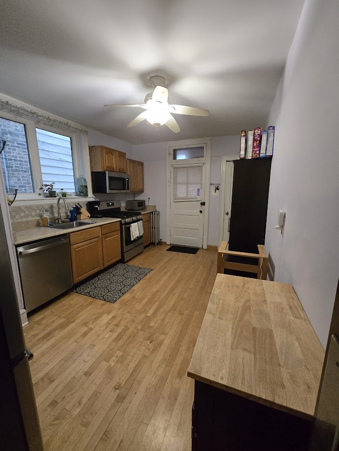 5910 North Campbell Avenue Chicago, IL 60659 - Photo 6 of 14 a kitchen with stainless steel appliances kitchen island granite countertop a refrigerator and a stove top oven