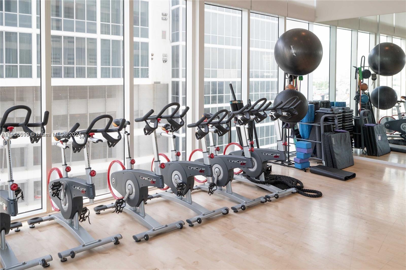 1040 Biscayne Boulevard, Unit 2607 Miami, FL 33132 - Photo 12 of 12 a room with gym equipment and lots of windows