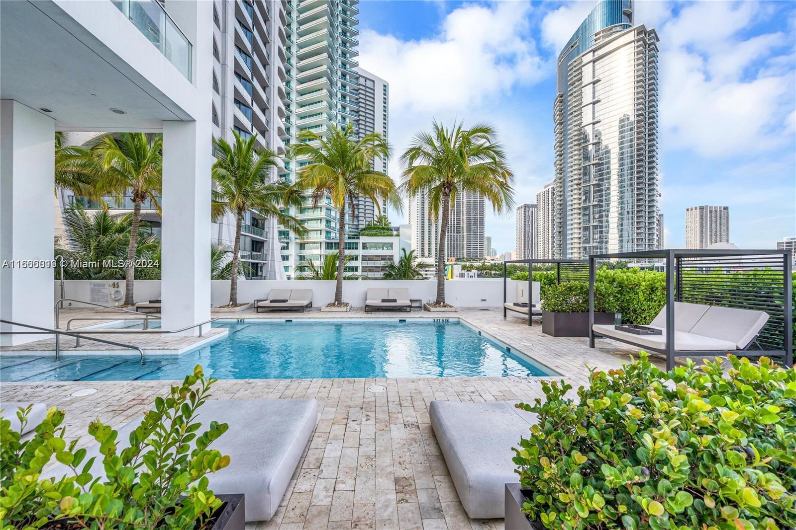 1040 Biscayne Boulevard, Unit 2607 Miami, FL 33132 - Photo 10 of 12 a swimming pool with outdoor seating and plants