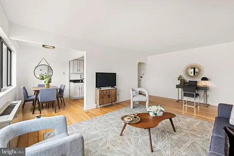 a living room with furniture a rug and a flat screen tv
