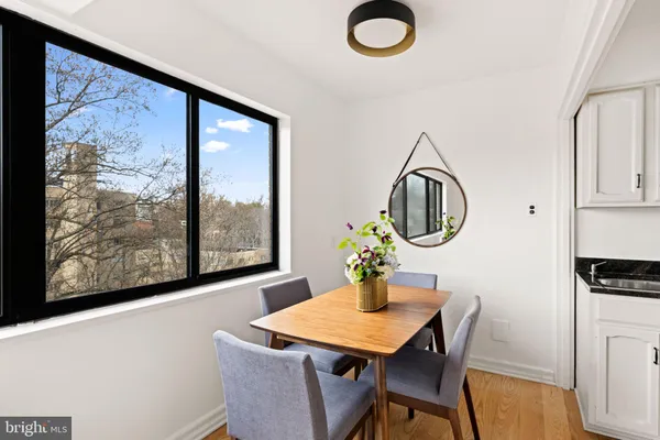 a view of a dining room with furniture window and wooden floor
