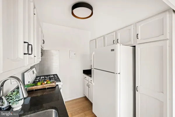 a white refrigerator freezer sitting inside of a kitchen