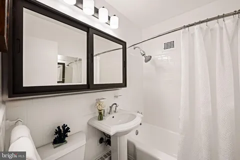 a bathroom with a sink a mirror and a bathtub