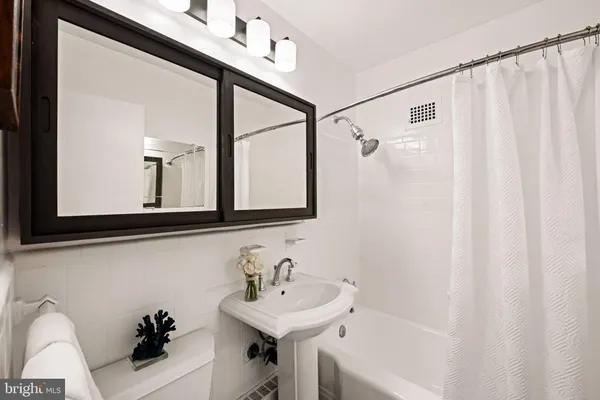 a bathroom with a sink a mirror and a bathtub