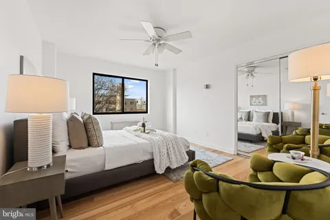 a bedroom with two beds and a chandelier