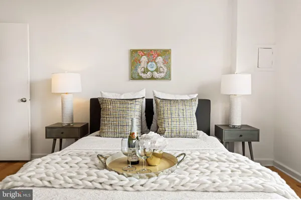 a bedroom with bed and a chandelier