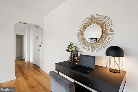 a living room with furniture and a mirror