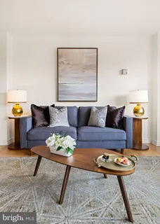 a living room with furniture and next to a table