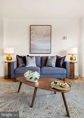 a living room with furniture and next to a table