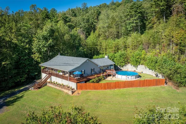 an aerial view of a house with yard swimming pool and outdoor seating