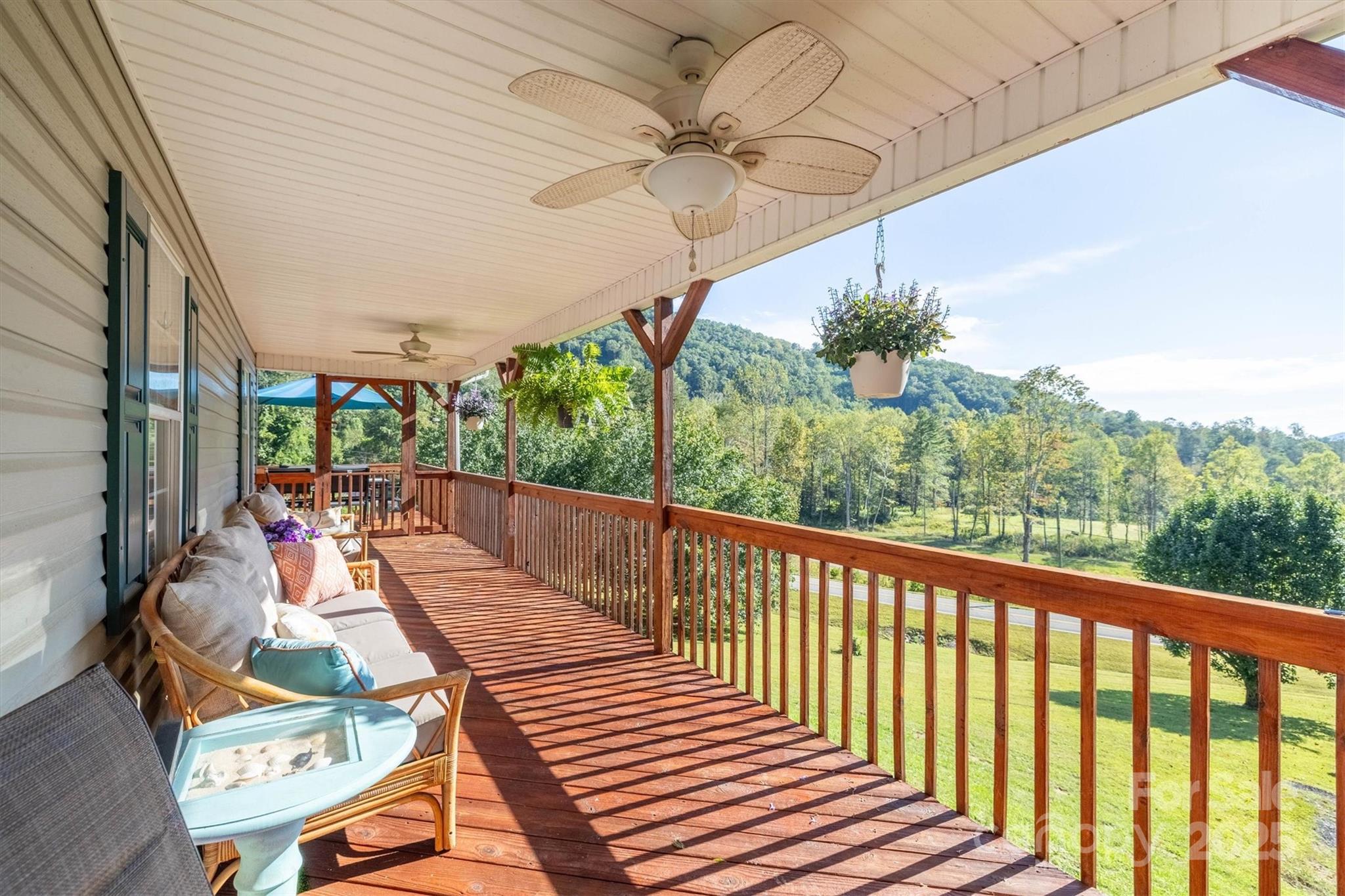 5933 Nubbin Creek Road Lenoir, NC 28645 - Photo 11 of 36 a view of a patio with a table chairs and a potted plant