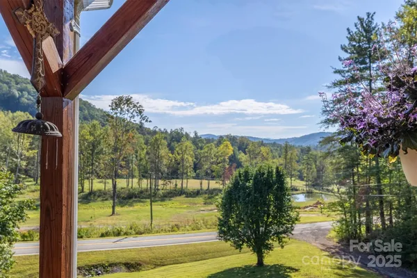 a view of balcony with furniture and umbrella