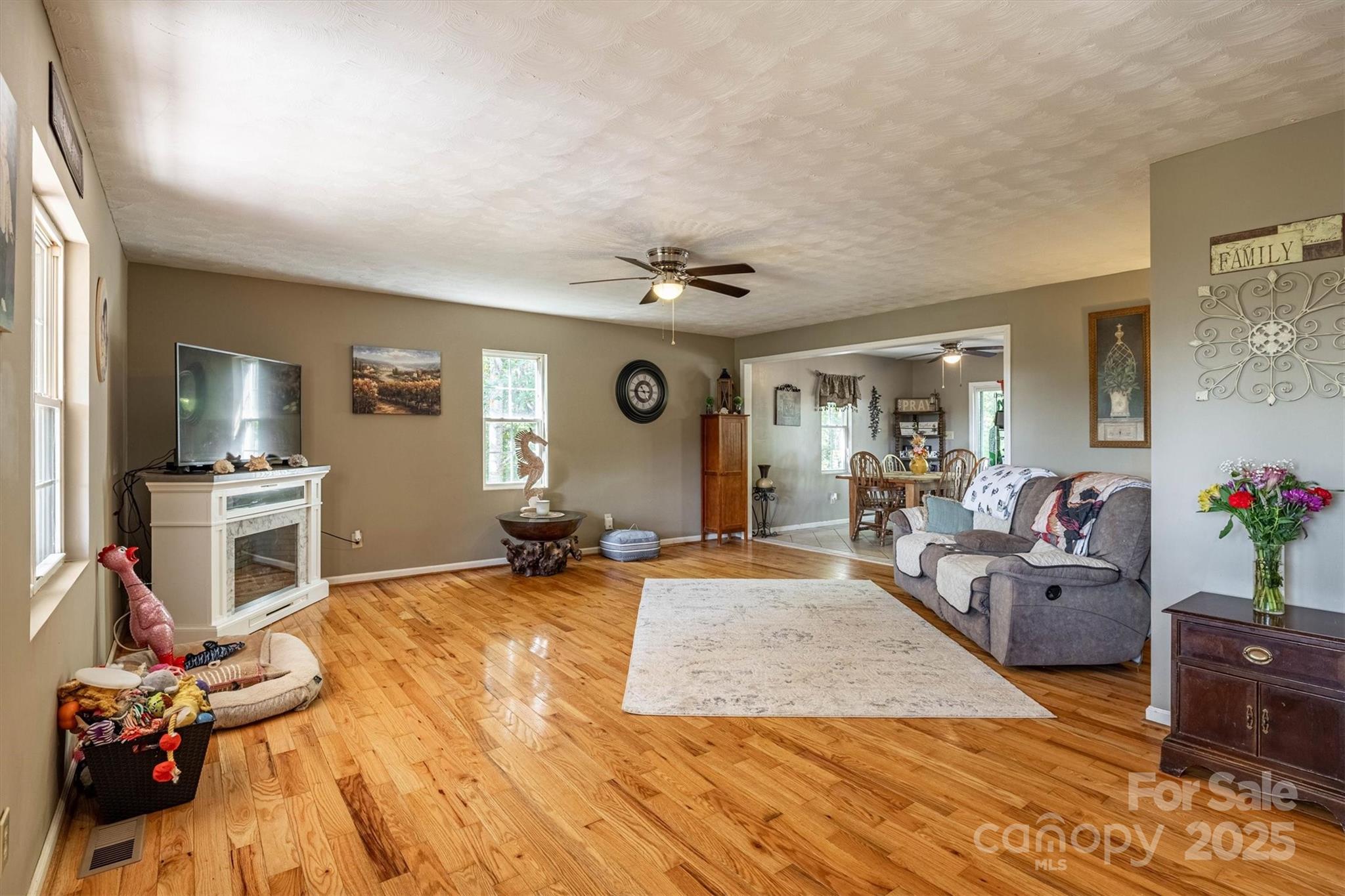 5933 Nubbin Creek Road Lenoir, NC 28645 - Photo 14 of 36 a living room with furniture gym equipment and a flat screen tv