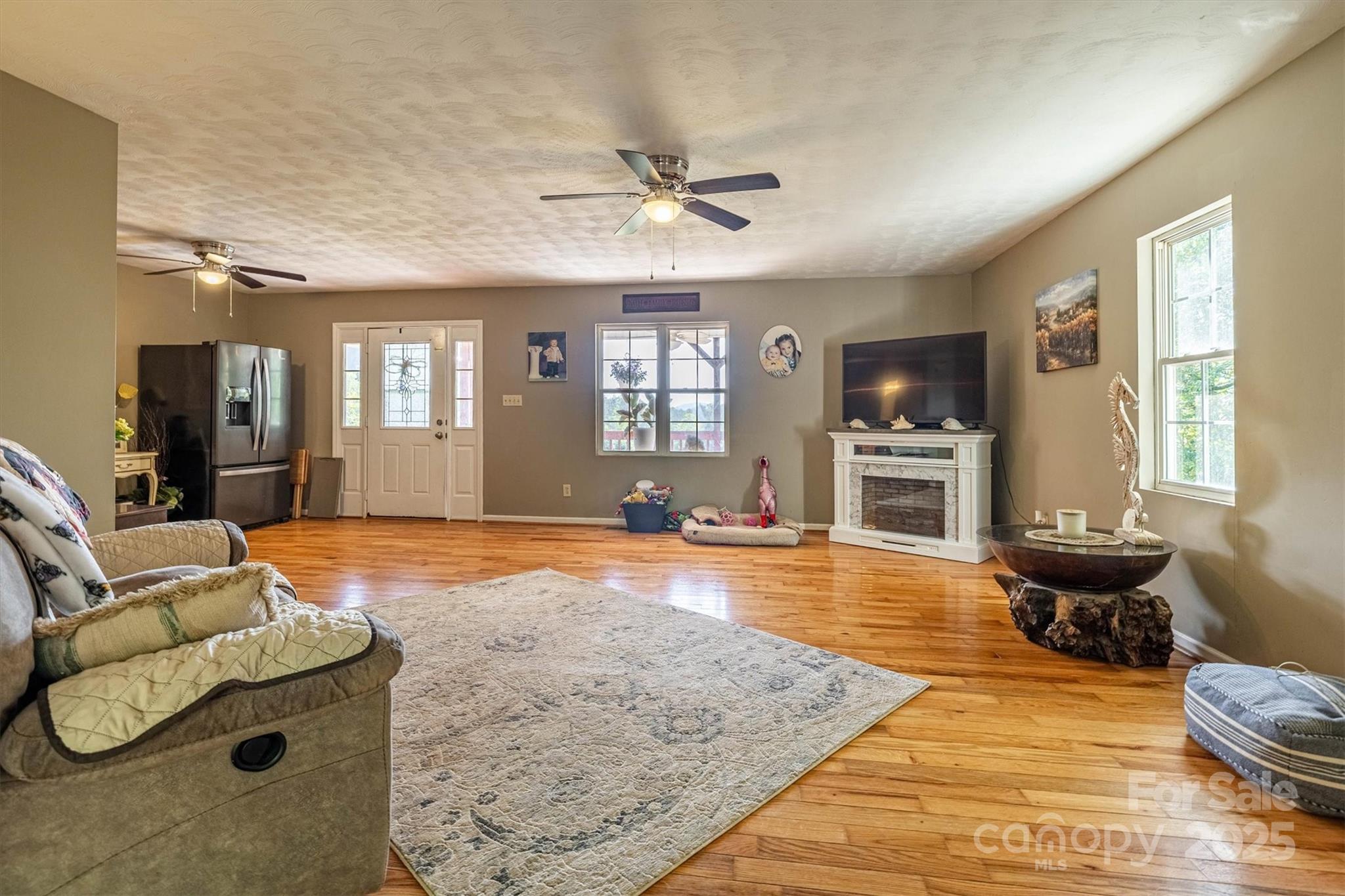 5933 Nubbin Creek Road Lenoir, NC 28645 - Photo 15 of 36 a living room with furniture and a wooden floor