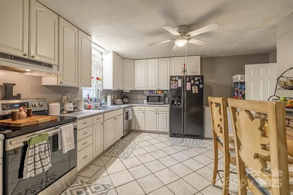 a kitchen with a sink cabinets and window