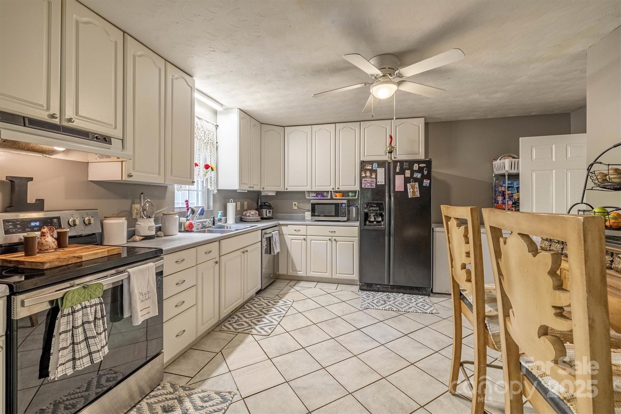 5933 Nubbin Creek Road Lenoir, NC 28645 - Photo 17 of 36 a kitchen with stainless steel appliances granite countertop a refrigerator sink and cabinets