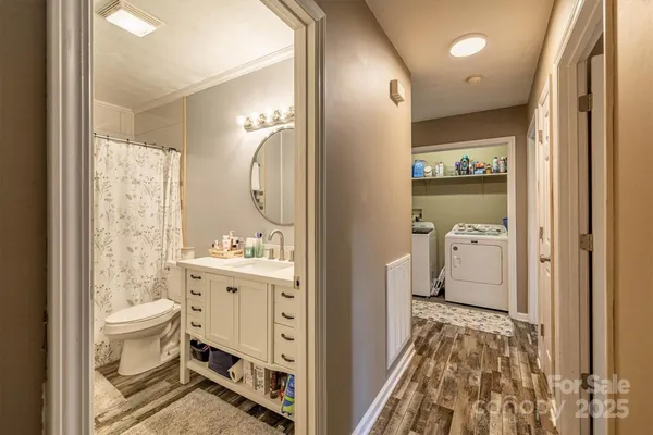 a bathroom with a double vanity sink toilet and shower