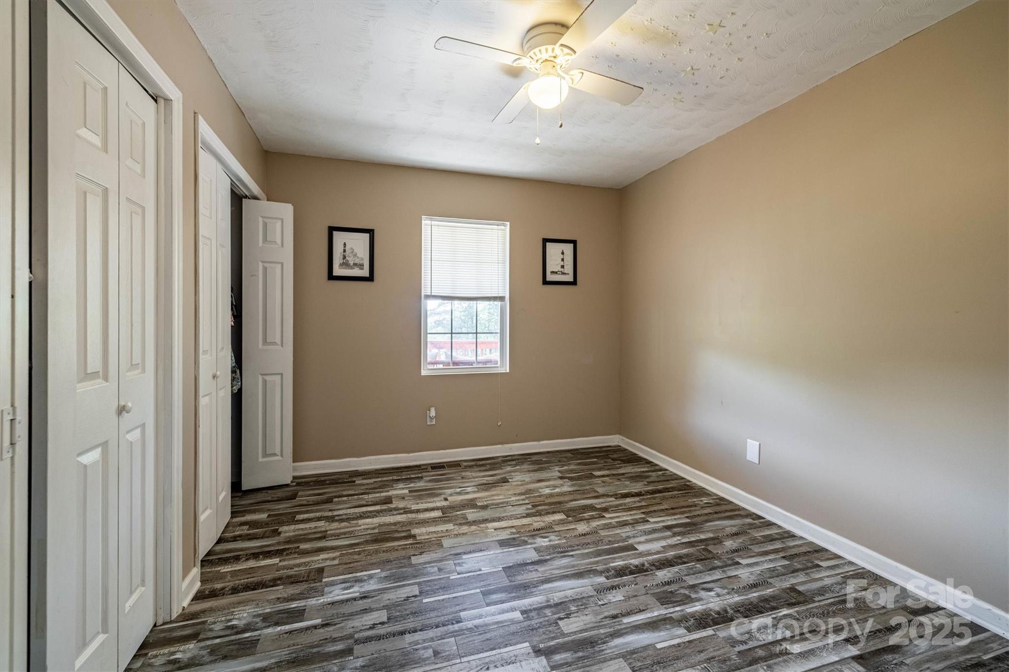 5933 Nubbin Creek Road Lenoir, NC 28645 - Photo 21 of 36 a view of an empty room with wooden floor and a window