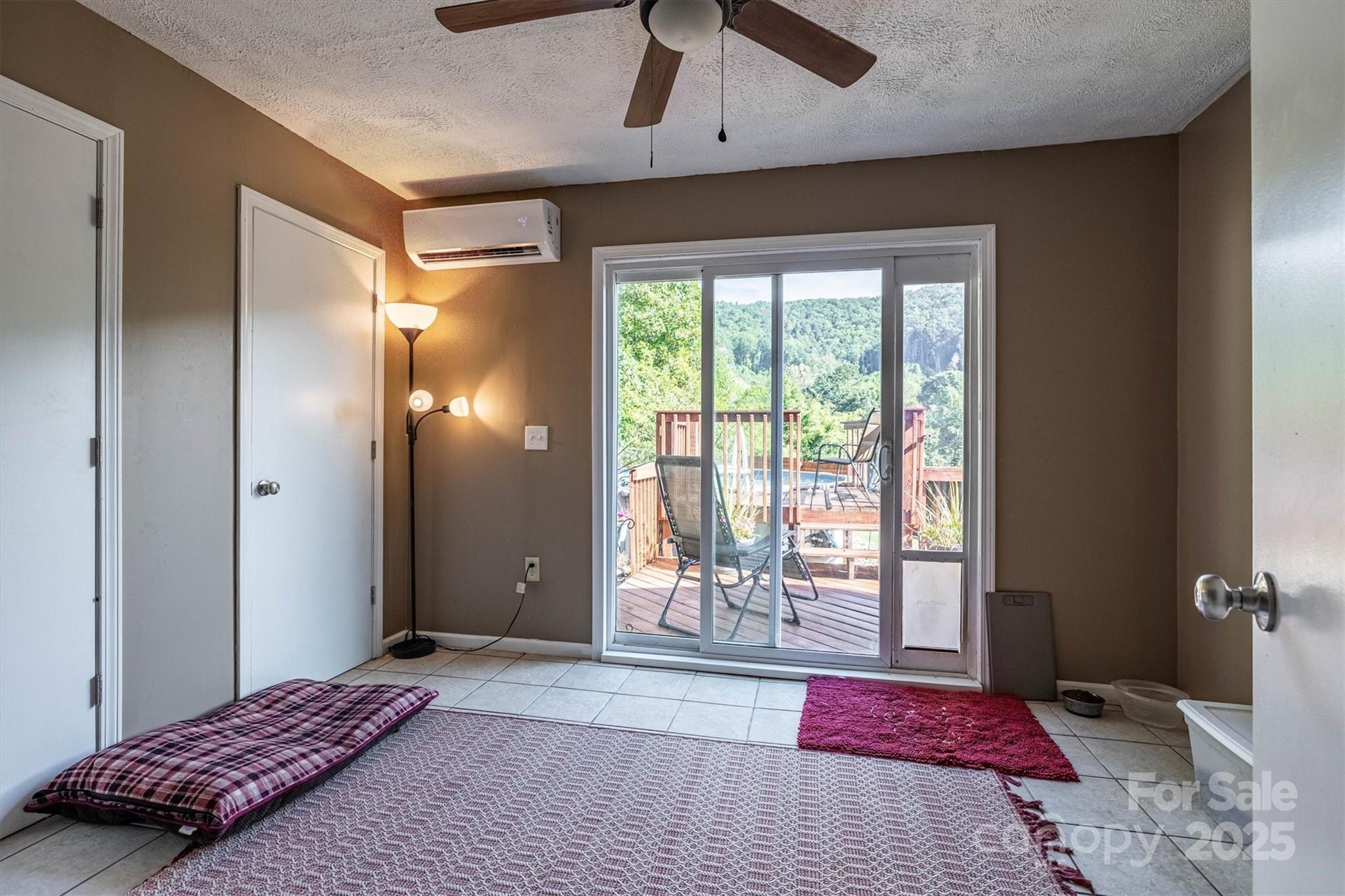 5933 Nubbin Creek Road Lenoir, NC 28645 - Photo 28 of 36 a bedroom with a bed and a large window