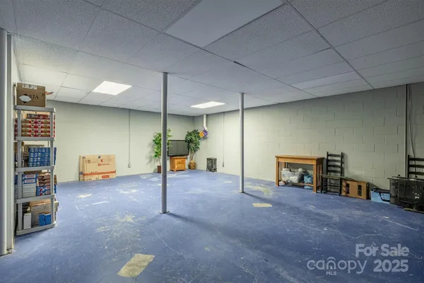 an empty room with furniture and a ceiling fan