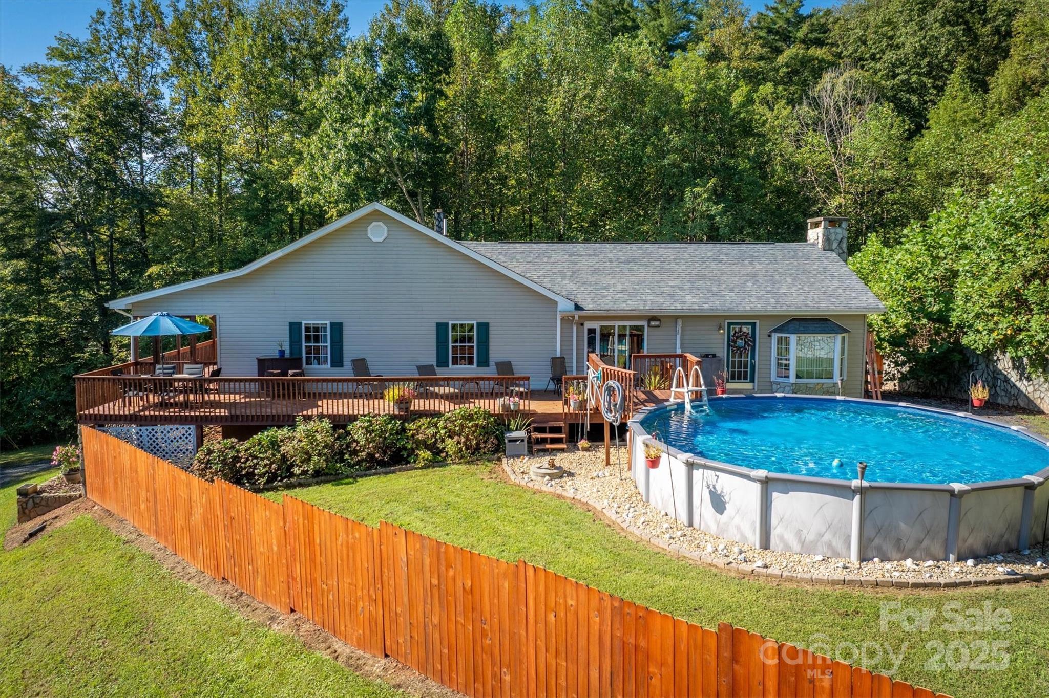 5933 Nubbin Creek Road Lenoir, NC 28645 - Photo 4 of 36 a front view of a house with a yard table and chairs