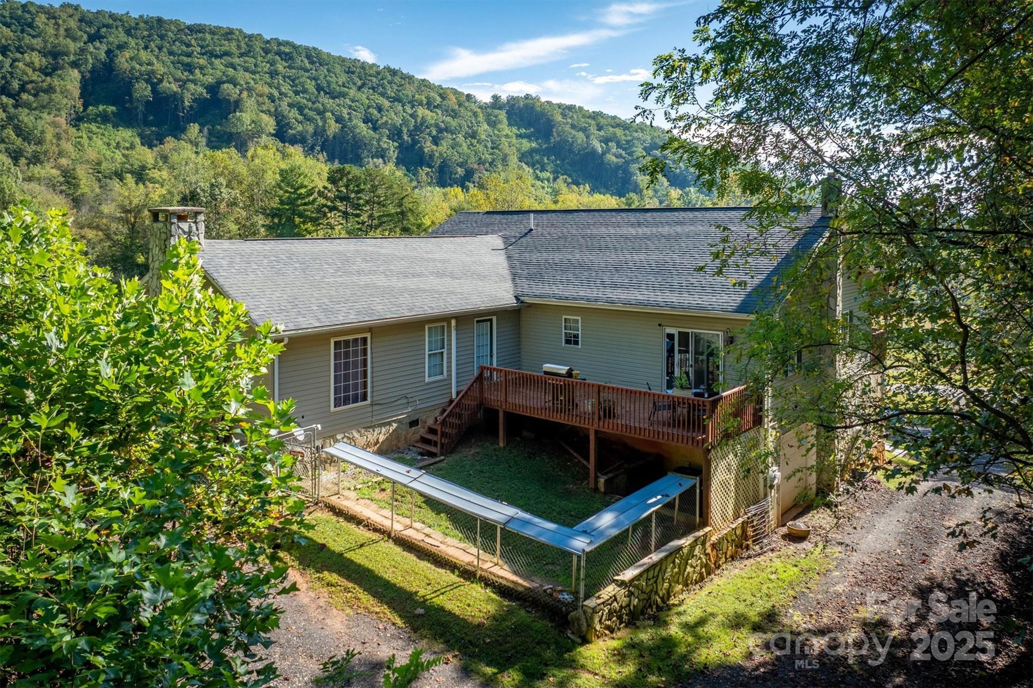 5933 Nubbin Creek Road Lenoir, NC 28645 - Photo 6 of 36 a view of house with a yard potted plants and large tree