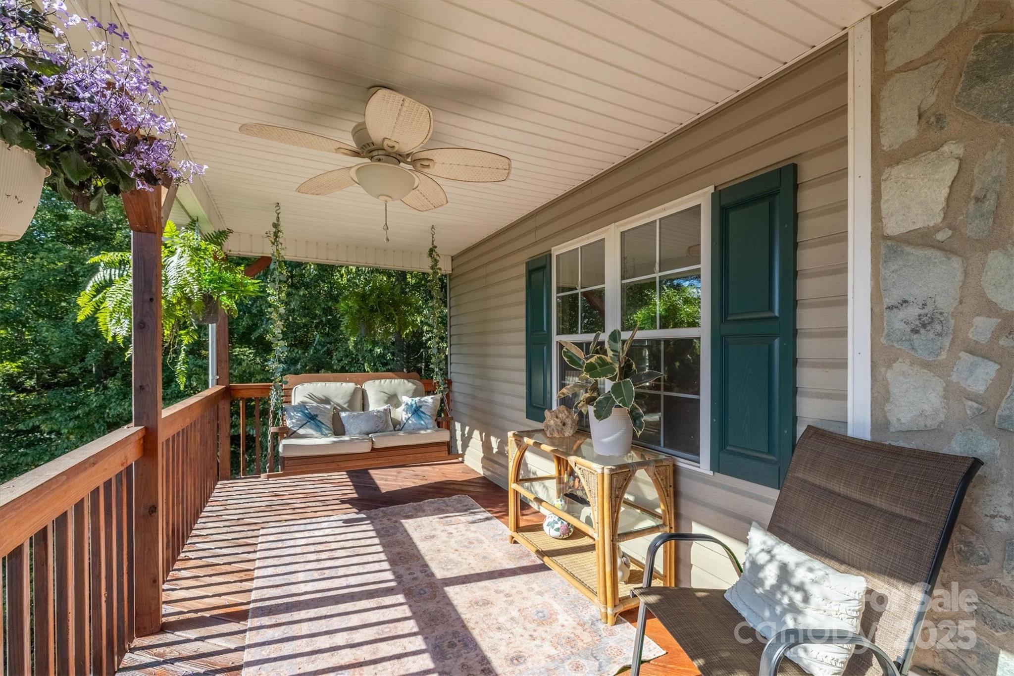 5933 Nubbin Creek Road Lenoir, NC 28645 - Photo 10 of 36 a view of a patio with a dining table and chairs with wooden floor and fence