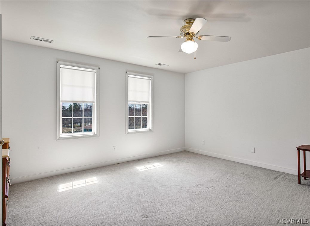 5011 Treely Road Chester, VA 23831 - Photo 20 of 50 an empty room with windows and ceiling fan