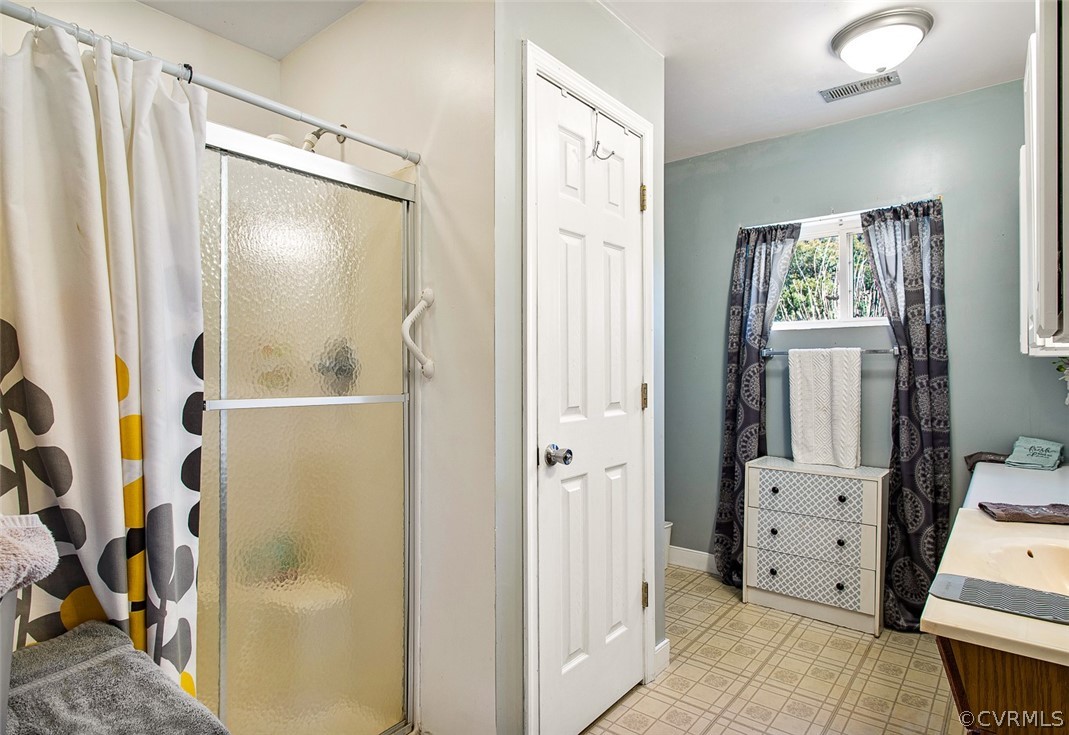 5011 Treely Road Chester, VA 23831 - Photo 31 of 50 a view of a bathroom with mirror and a wooden floor