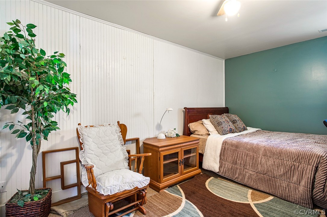 5011 Treely Road Chester, VA 23831 - Photo 33 of 50 a bedroom with a bed table and a potted plant