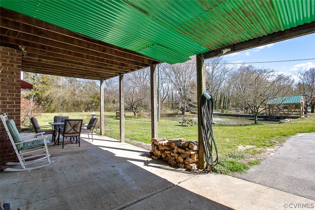 5011 Treely Road Chester, VA 23831 - Photo 34 of 50 a view of a patio with table and chairs under an umbrella