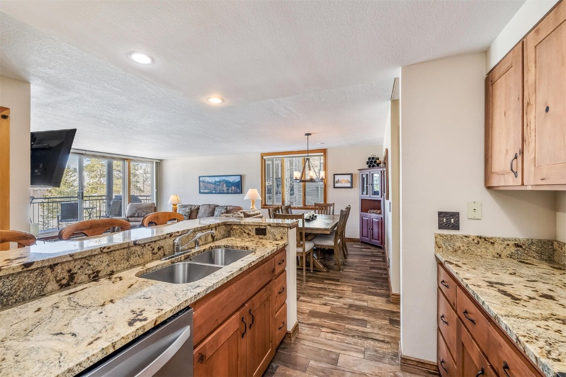 21630 Highway 6, Unit 2149 Keystone, CO 80435 - Photo 11 of 35 a kitchen with granite countertop a sink stove and cabinets