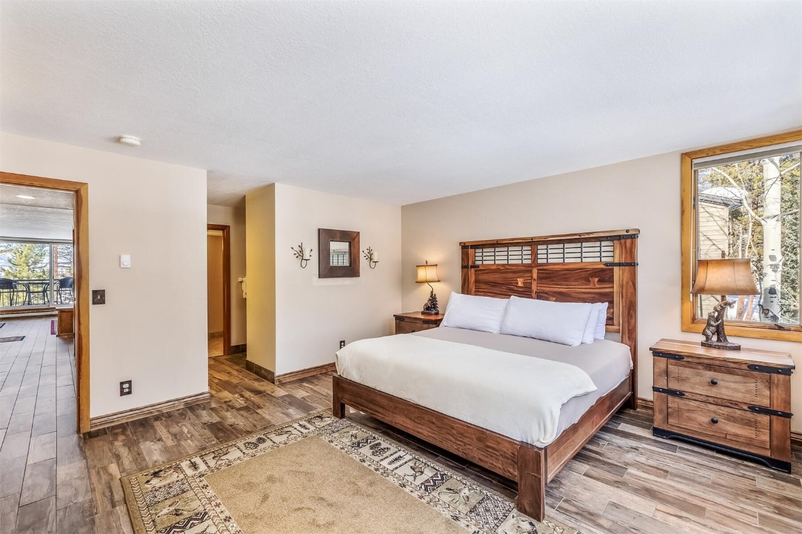 21630 Highway 6, Unit 2149 Keystone, CO 80435 - Photo 14 of 35 a bedroom with a bed and wooden floor