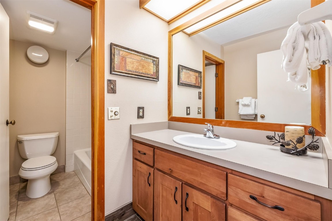 21630 Highway 6, Unit 2149 Keystone, CO 80435 - Photo 20 of 35 a bathroom with a sink a toilet and a mirror