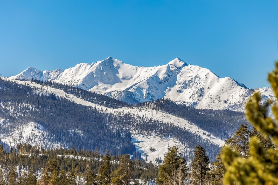 21630 Highway 6, Unit 2149 Keystone, CO 80435 - Photo 22 of 35 a bed with white sheets and a blanket