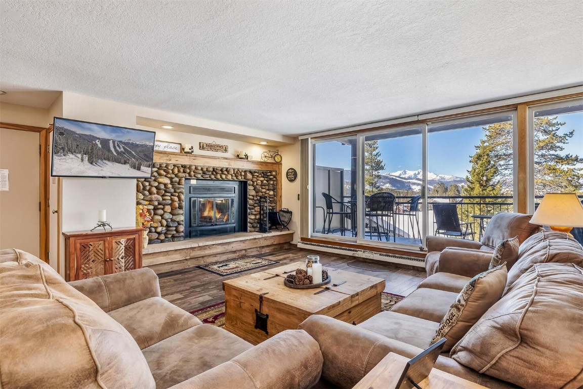 21630 Highway 6, Unit 2149 Keystone, CO 80435 - Photo 6 of 35 a living room with furniture large window and a fireplace