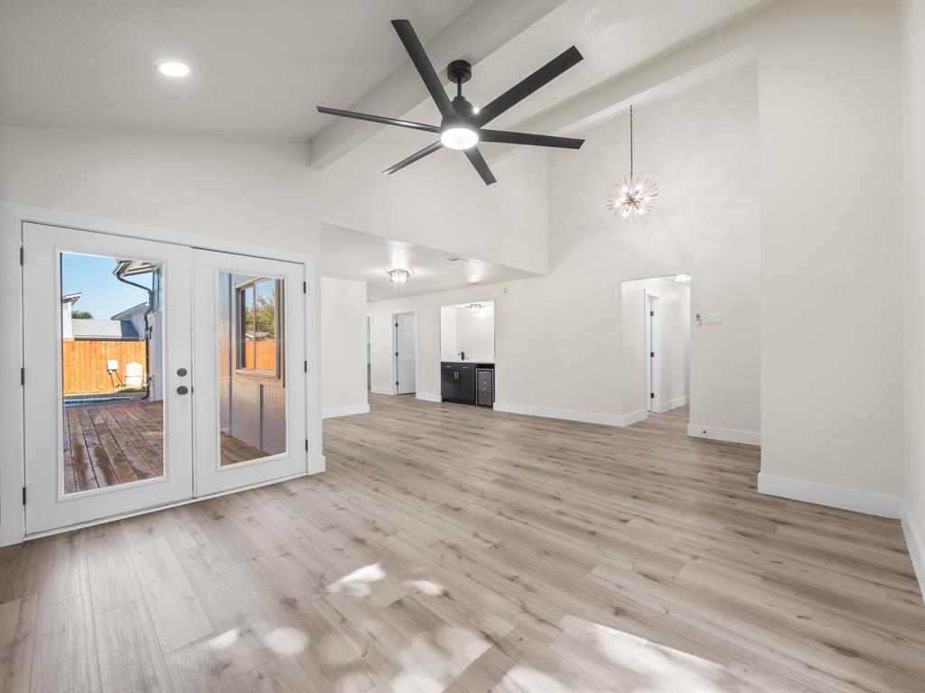 2127 Wheaton Drive Richardson, TX 75081 - Photo 14 of 33 an empty room with wooden floor and a ceiling fan