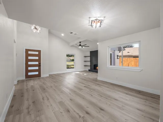 an empty room with windows and cabinet