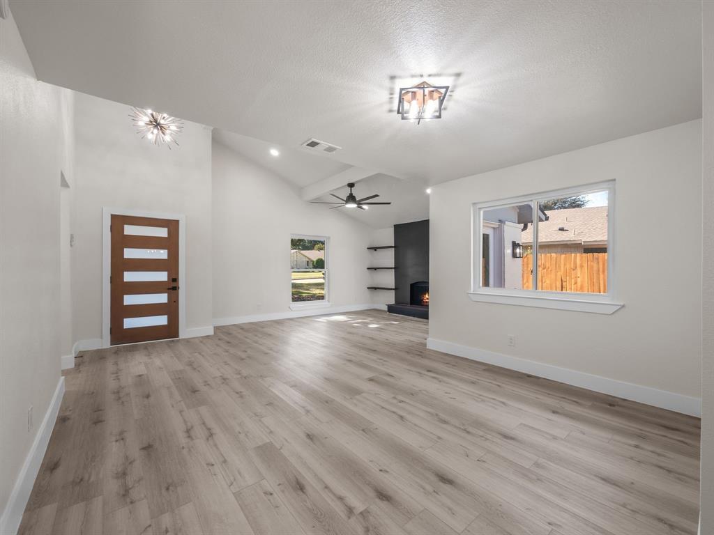 2127 Wheaton Drive Richardson, TX 75081 - Photo 16 of 33 an empty room with windows and cabinet