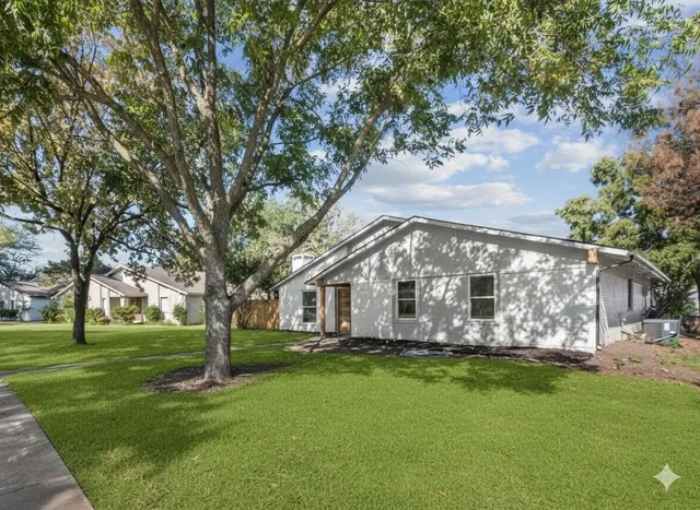 a view of house with backyard