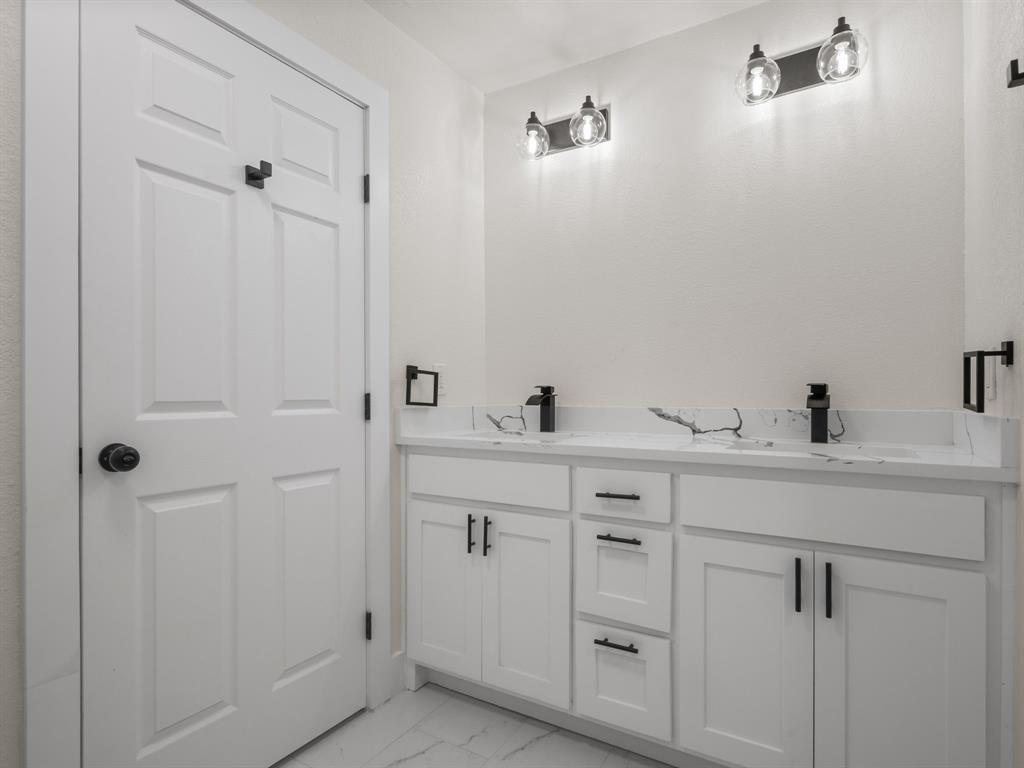 2127 Wheaton Drive Richardson, TX 75081 - Photo 24 of 33 a bathroom with a sink and a mirror