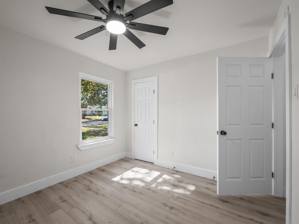2127 Wheaton Drive Richardson, TX 75081 - Photo 25 of 33 a view of empty room with wooden floor and fan