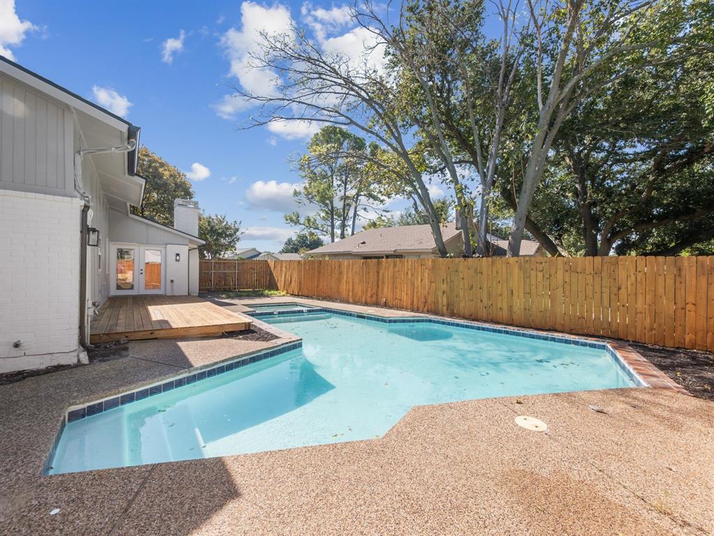 2127 Wheaton Drive Richardson, TX 75081 - Photo 32 of 33 a backyard of a house with table and chairs