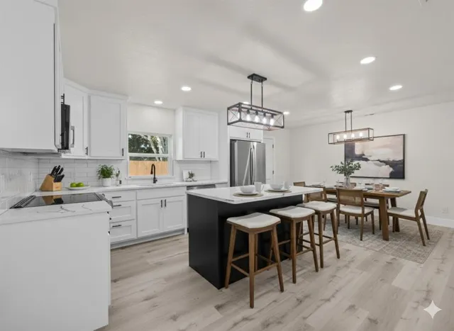 a kitchen with a table chairs stove and cabinets